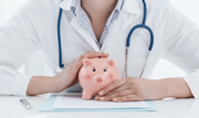 Female doctor with piggy bank